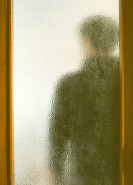 Férfi fekete mögött zárt ajtó üvegen keresztül — Stock Fotó