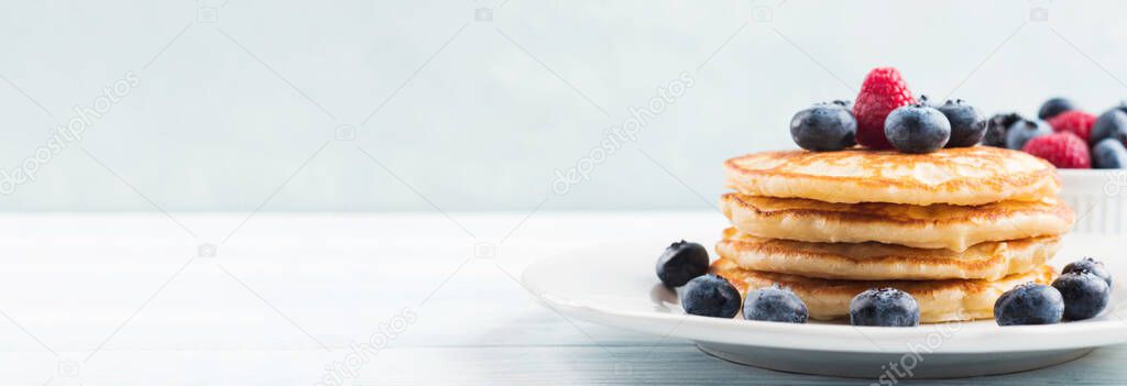 Stack of pancakes with blueberries and syrup