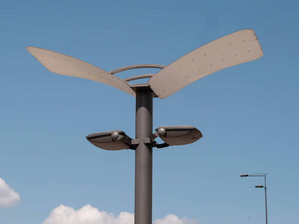 Modern street lamp on a blue sky background.