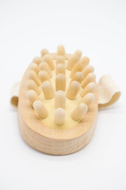 Elinde kemer olan bir ağaçtan masaj tarağı.