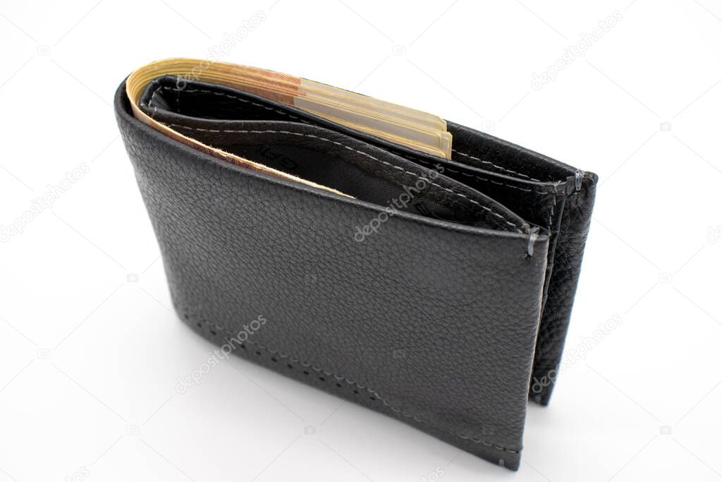 A purse with money on a white background and a hand that counts bills.