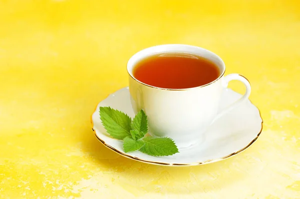 Cup Tea Saucer Mint Leaf Yellow Background — Stock Photo, Image