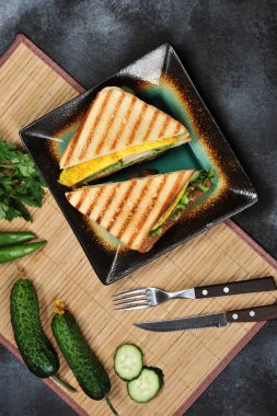 Marul, jambon, yumurta ve domates ile sandviç ekmeği üstten görünüm koyu arka plan üzerinde