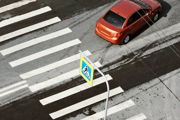 car and zebra pedestrian crossing and sign of a pedestrian crossing across the road - top view - road safety