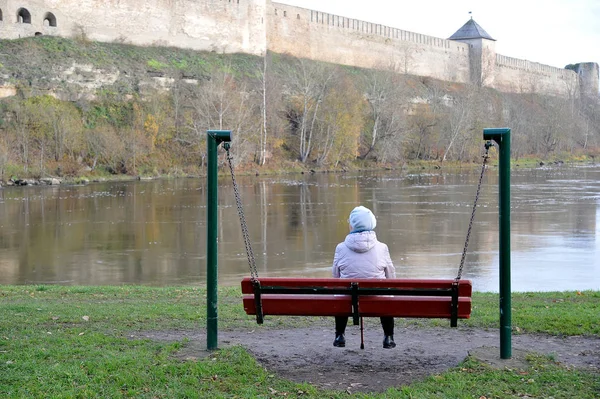 Elderly Woman Pensioner Sitting Bench Looking River Ancient Fortress — Stock Photo, Image