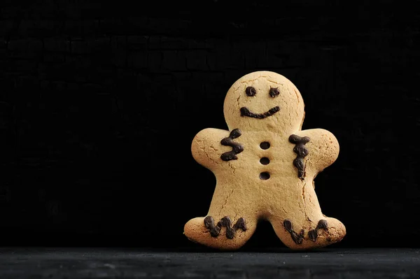 gingerbread man on a black background - close-up