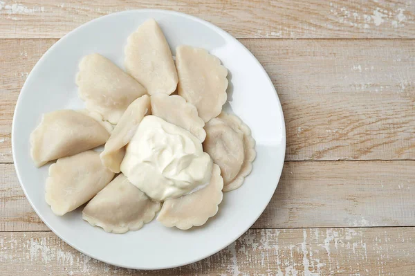 Dumplings Med Gräddfil Platta Trä Bakgrund Ovanifrån — Stockfoto