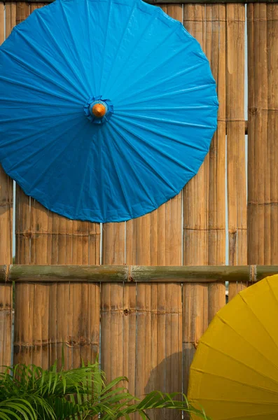 Deel Van Blauwe Gele Papieren Paraplu Opknoping Bamboe Houten Muur — Stockfoto
