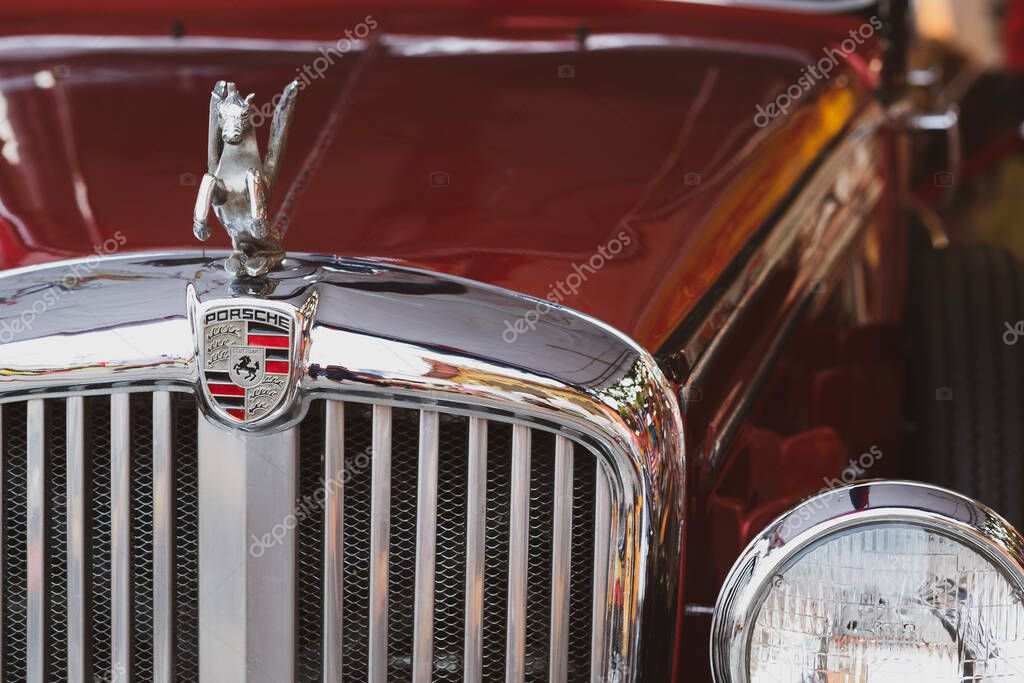 Samutsakorn, Thailand - March17,2020 ; Close up silver Pegasus statue on sparkle chrome with front headlight of the old vintage red Porsche classic car