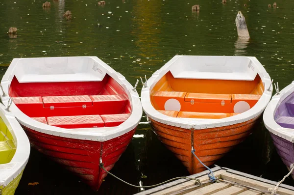 Красочные лодки причаливали на краю горного озера в осенний сезон . — стоковое фото