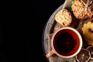 Bir kupa ile şenlikli bileşimi sıcak çay, kurabiye ve spicies bir ahşap varil, seçici odak, yakın çekim