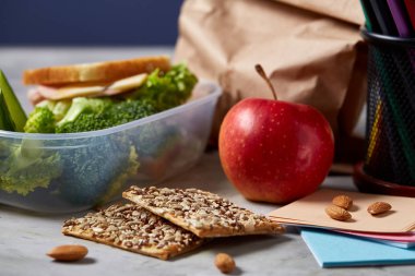 Geri okul kavramı, okul malzemeleri, bisküvi, paket öğle yemeği ve beslenme çantası beyaz Danışma, seçici odak, yakın çekim için.