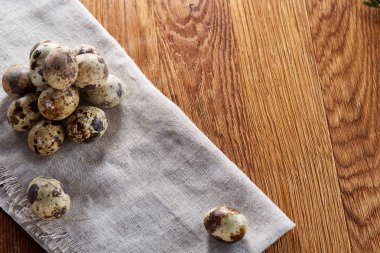 Piramit peçeteye düzenlenen bir ahşap masa, yakın çekim, seçici odak üzerinde bıldırcın yumurtası.