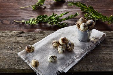 Bıldırcın yumurtası keten peçete ve Şimşir dal, seçici odak demet bahar bileşimi