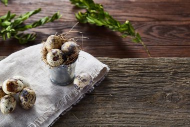 Bıldırcın yumurtası keten peçete ve Şimşir dal, seçici odak demet bahar bileşimi