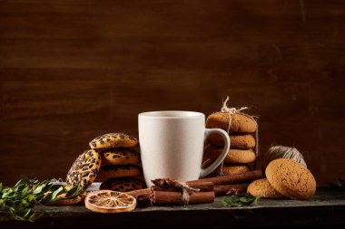 Geleneksel Noel çay bir fincan sıcak çay, kurabiye ve süslemeleri üzerinde ahşap bir masa, seçici odak konseptiyle