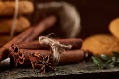 Tanımlama bilgileri, tarçın ve ahşap arka plan üzerinde kurutulmuş portakal yığını ile Noel kompozisyon yakın çekim.