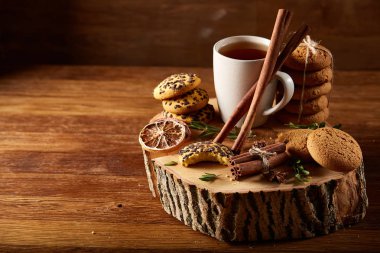 Bir fincan sıcak çay, kurabiye ve dekorasyon ahşap arka plan, seçici odak üzerinde bir oturum ile Noel kavramı