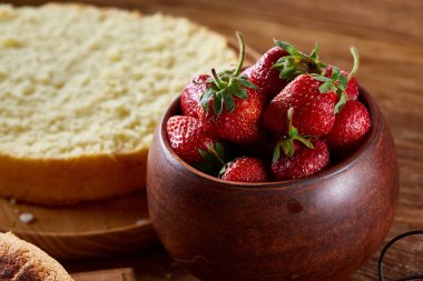 Yemek kek bir kabın içinde ahşap arka plan üzerinde seçici odak için çilek