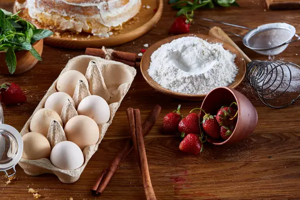Top view ingrédients bruts pour la cuisson tarte aux fraises ou gâteau sur une table en bois, pose plate. Contexte boulangerie . — Photo