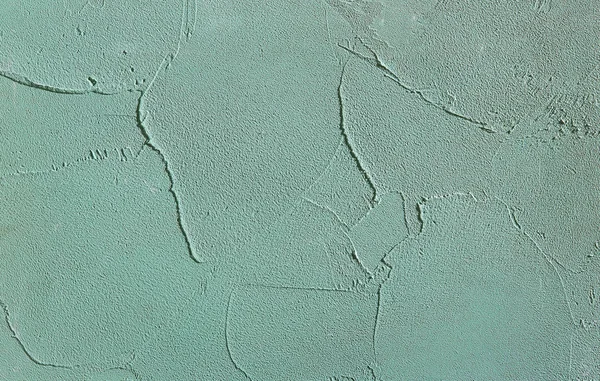 Green rough wall textured background. Abstact stucco. Texture of plaster on the wall.