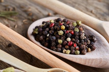 Aromatik kaşıklarla eski ahşap masa, yakın çekim, düz yemek pişirmek için çeşitli baharatlar yatıyordu, seçici odak.