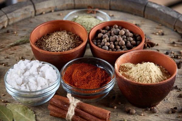 Ahşap varil, yakın çekim, seçici odak, dikey üst Seramik kase içinde baharatlar.