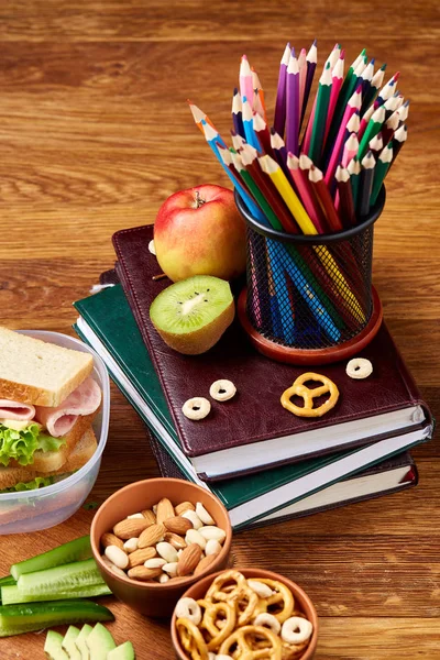 Okul veya sandviç ile öğle yemeği kutusu ve çeşitli renkli sebze ve meyve ahşap arka plan üzerinde piknik, yakın çekim.