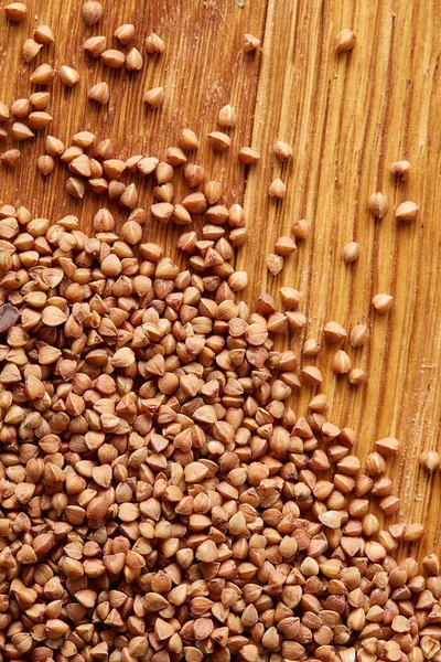 Karabuğday kabuğu çıkarılmış tane ahşap arka plan, üstten görünüm, yakın çekim, seçici odak.