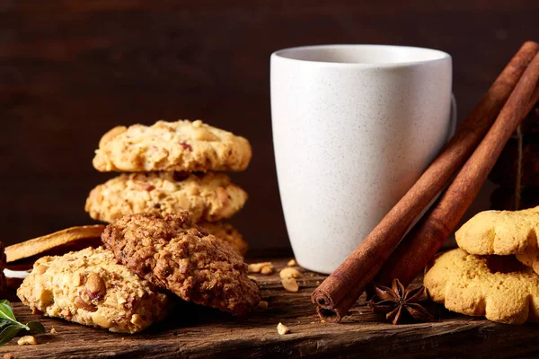 Kavramsal şenlikli bileşimi ile bir fincan sıcak çay, kurabiye ve spicies bir ahşap varil, seçici odak, yakın çekim