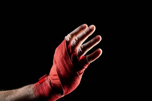 Боксерський червоний бинт на руці ізольований на темному розмитому фоні, крупним планом . — стокове фото