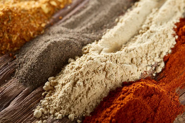 Colorful spice background with different color spices, macro, selective focus, shallow depth of field.