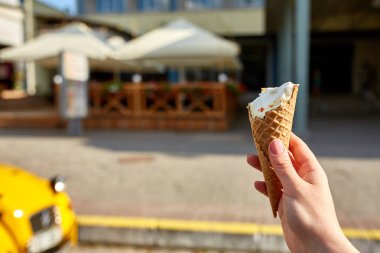 İlk kişi görüntüleyebilir, bir kişi bir dondurma sığ derinlik-in tarla onun elinde olan yol boyunca yürüyüş.
