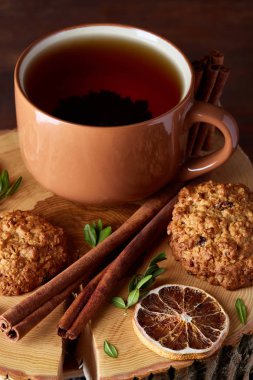 Bir fincan sıcak çay, kurabiye ve dekorasyon ahşap arka plan, seçici odak üzerinde bir oturum ile Noel kavramı