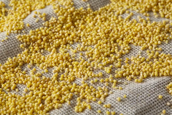 Two bowls of millet on a wooden background, top view, close-up, selective focus.