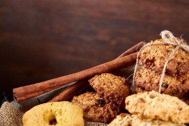 Tanımlama bilgileri ve tarçın ile ahşap bir varil, seçici odak peçeteye ürün çeşitliliği ile kavramsal kompozisyon