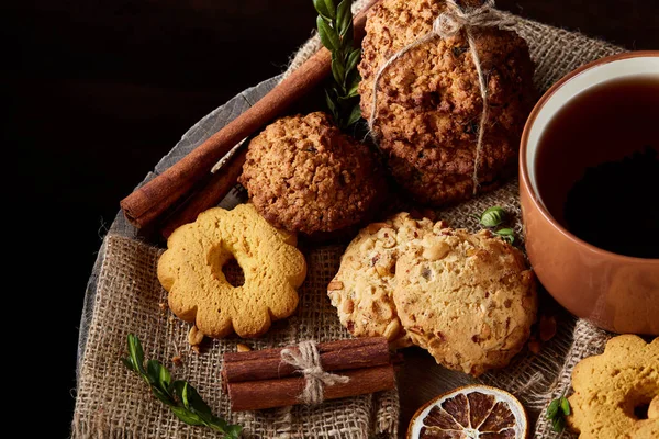 Tarçın ve iki bardak çay bir çuval bezi peçete, seçici odak, yakın çekim, üstten görünüm ile tatlılar.