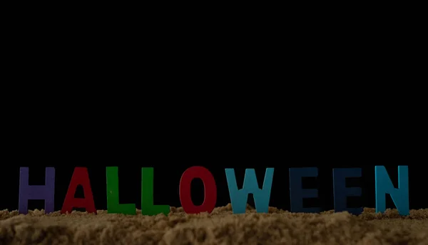 Alphabet Halloween in sand on black background, — Stock Photo, Image