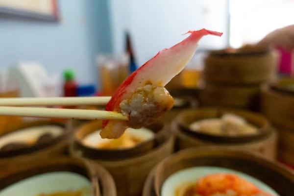 Wooden chopsticks are dim sum on the table. Stock Image