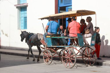 Holguin, Cuba 12.12.2018 Local horse drawn carriage taxi waiting for customers clipart