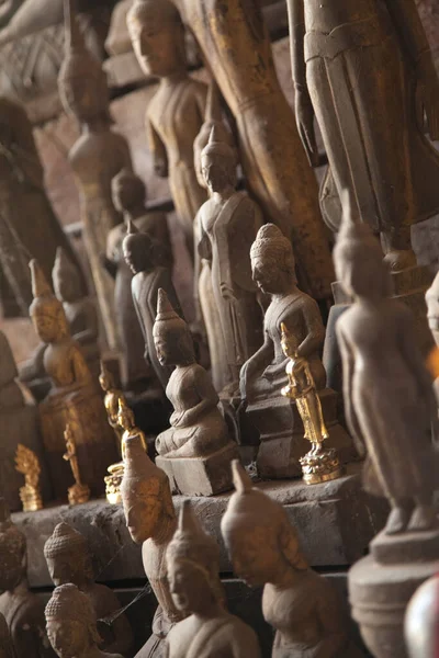 Ou Pak Caves Laos two caves on the west side of the Mekong river, with small and miniature Buddha statues in many different poses placed there for safe keeping and are frequently visited by tourists.