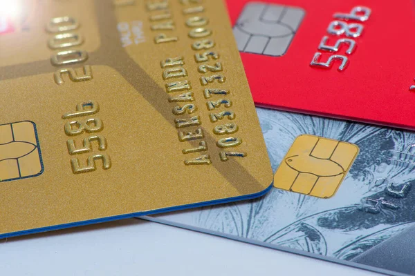 Three Bank cards of payment systems, gold red and gray
