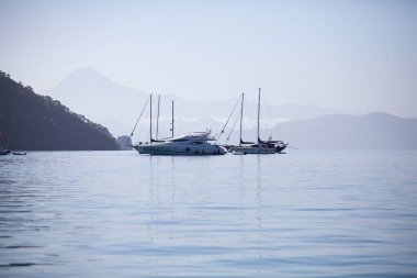 Denizde yelkenli kayalıkların kıyısında