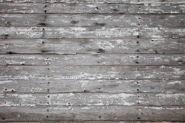 Eski tahta duvarın dokusu ve beyaz boya kalıntıları.
