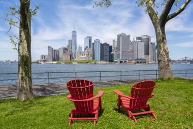 Chairs facing the skyline in New York City clipart
