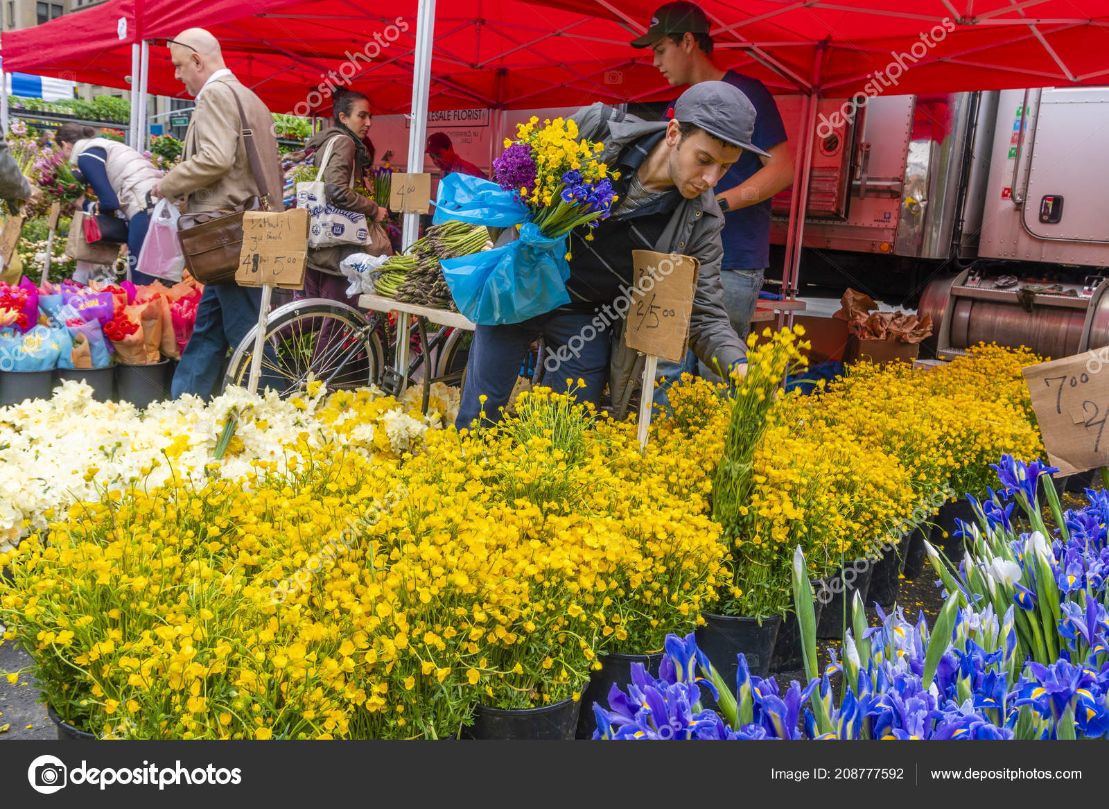 People buying flowers at a street market in New York City Stock