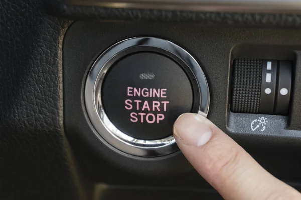 Pushing the engine start stop button of a car — Stock Photo, Image