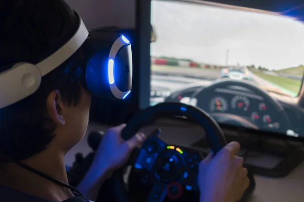 Playing racing video game with VR headset at home — Stock Photo, Image