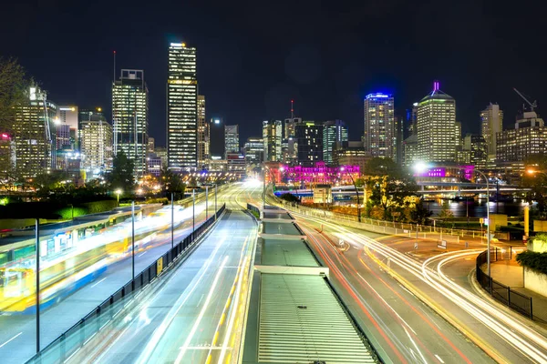 Bus station and modern buildings at night — Stock Photo, Image