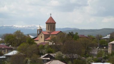 Georgia'daki Hıristiyan kilisesi. Arka planda karla kaplı dağlar var..